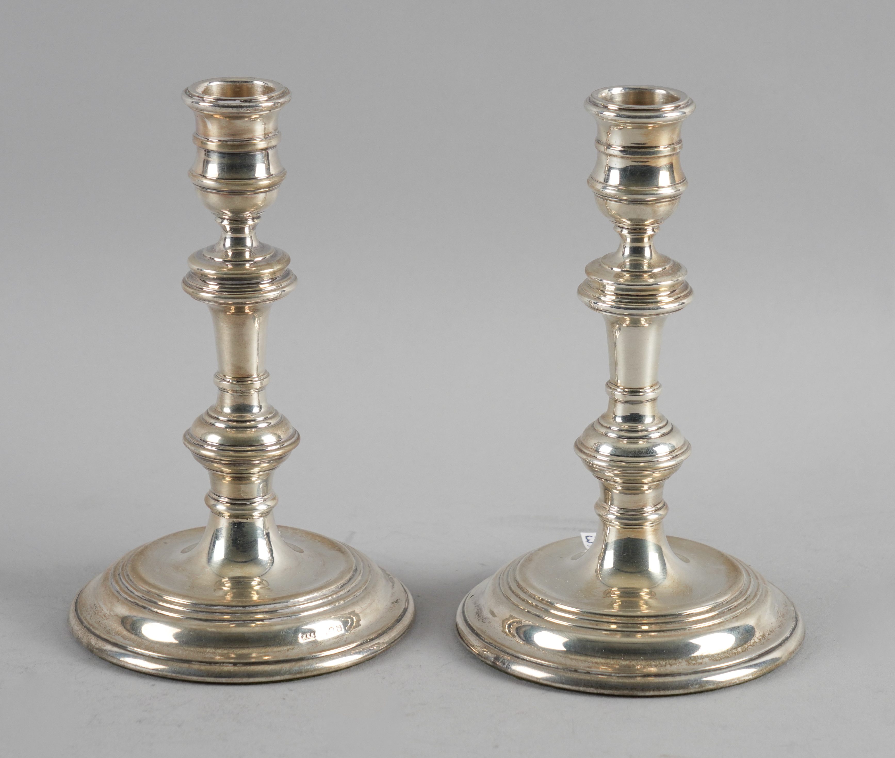 A PAIR OF SILVER CANDLESTICKS