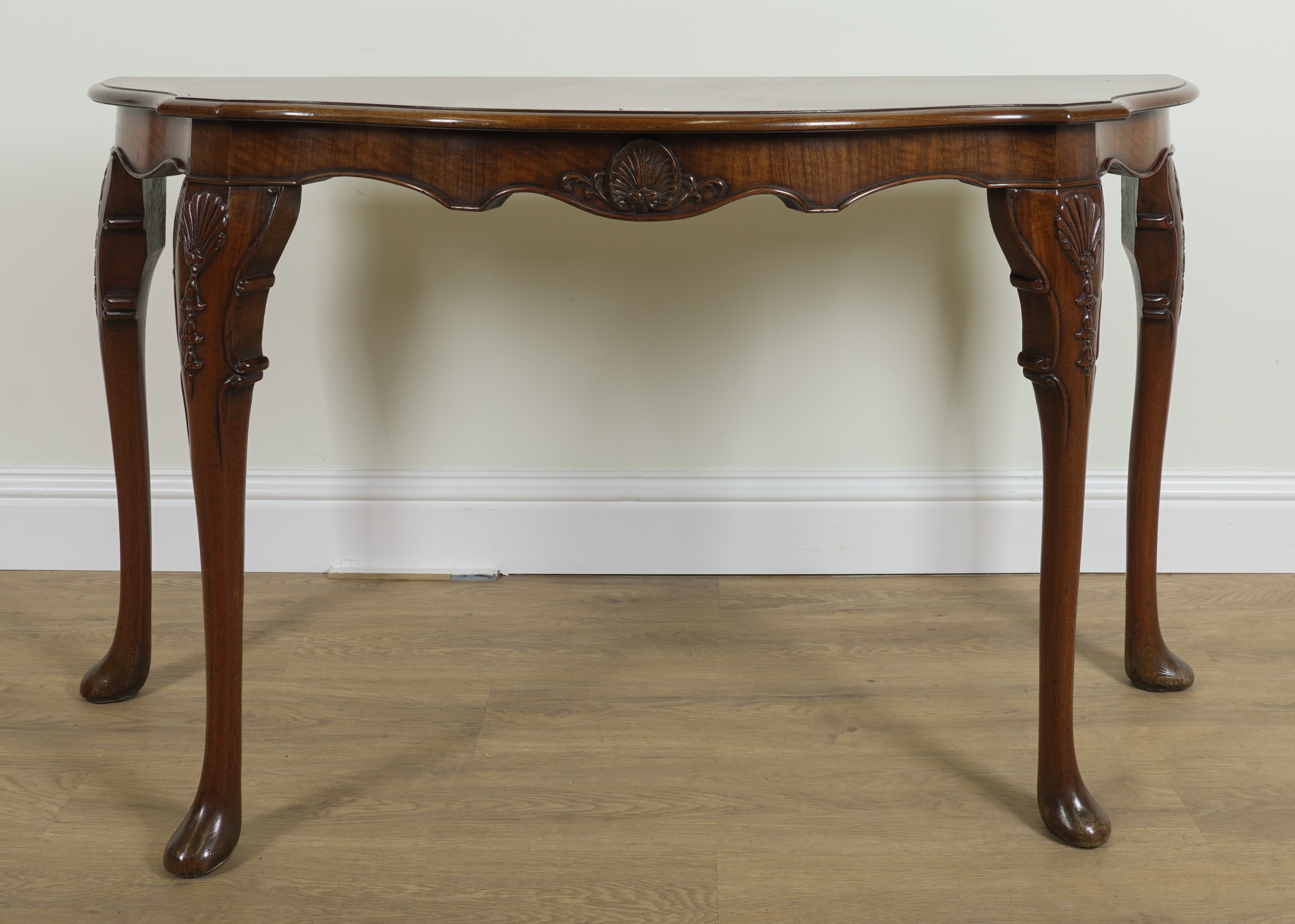 A GEORGE I STYLE FIGURED WALNUT CONSOLE TABLE