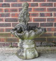 A RECONSTITUTED STONE SHELL SHAPED BIRD BATH