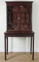 A GEORGE III AND LATER MAHOGANY TWO DOOR DISPLAY CABINET ON STAND