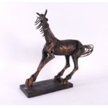 A PATINATED METAL ALLOY SCULPTURE OF A HORSE