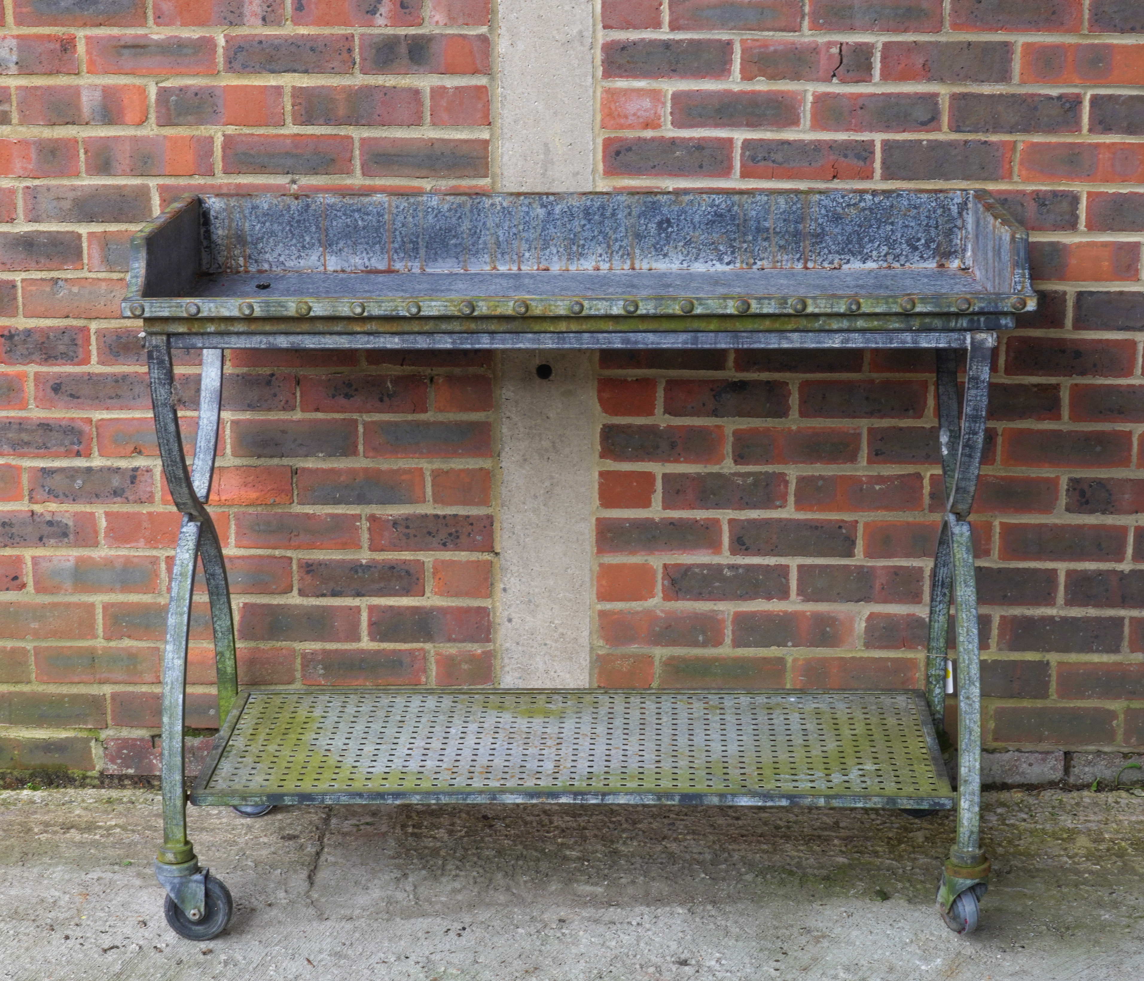 A MODERN RIVETED METAL GARDEN/ POTTING SHED TABLE