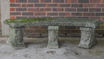 A RECONSTITUTED STONE CONCAVE GARDEN BENCH