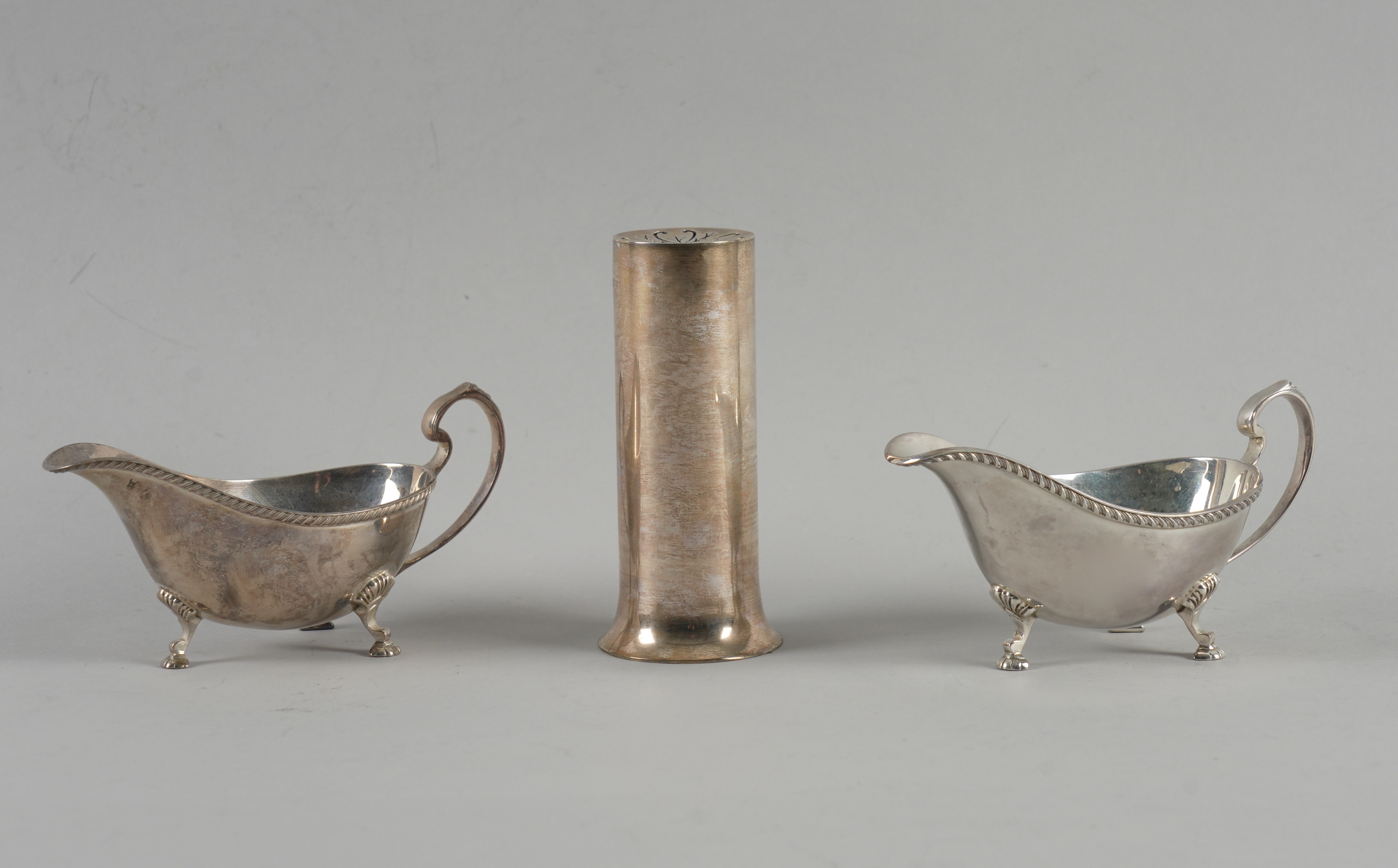 A PAIR OF SILVER SAUCEBOATS AND A SILVER SUGAR SIFTER (3)