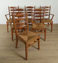 A SET OF SIX MID 20TH CENTURY OAK AND YEW WOOD PIERCED LADDER BACK DINING CHAIRS (6)