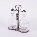 ASPREY & CO: A SILVER-PLATED LOCKABLE TANTALUS WITH TWO DECANTERS