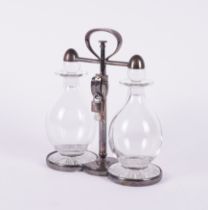 ASPREY & CO: A SILVER-PLATED LOCKABLE TANTALUS WITH TWO DECANTERS