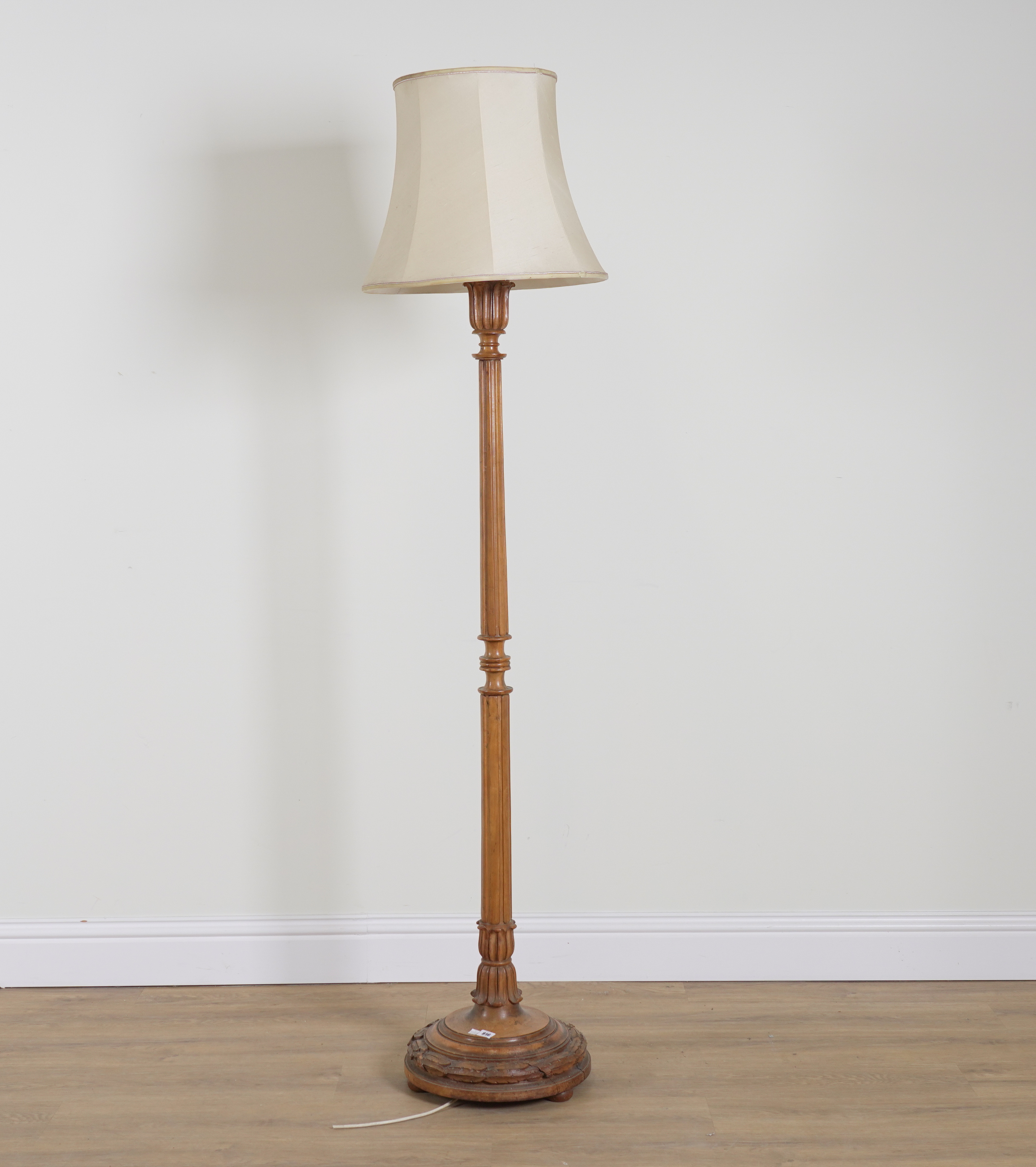 AN EARLY 20TH CENTURY FRENCH CARVED WALNUT STANDARD LAMP