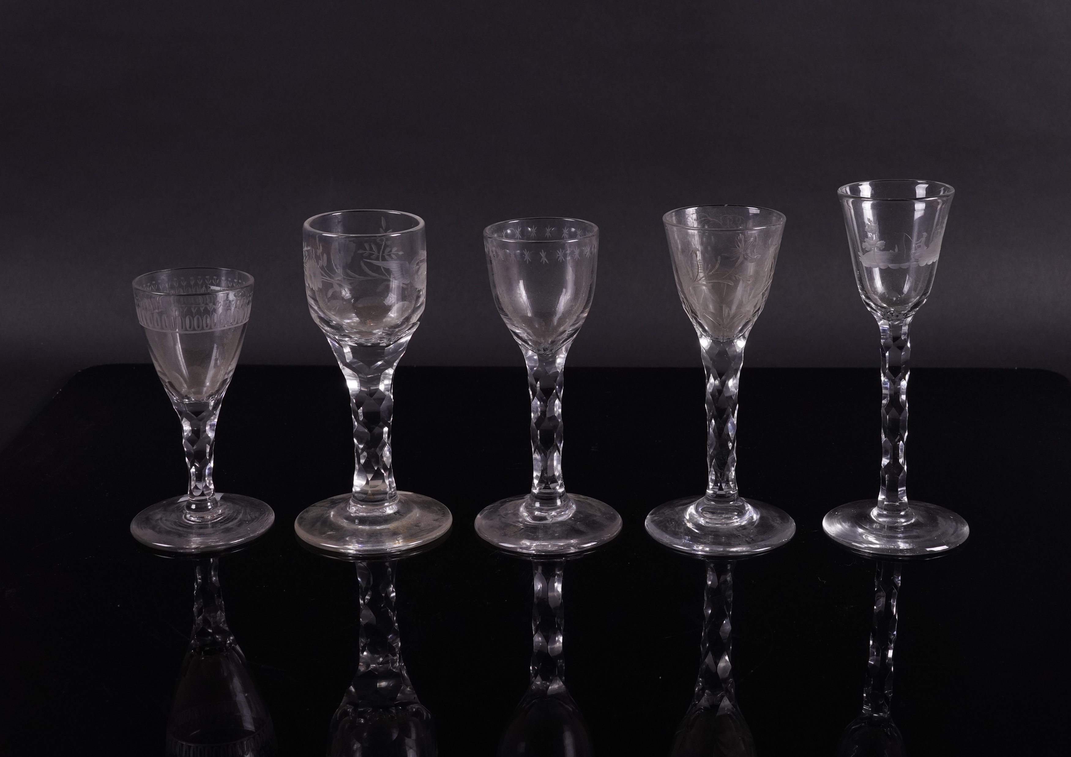 FIVE ENGRAVED FACET STEMMED WINE GLASSES (5)