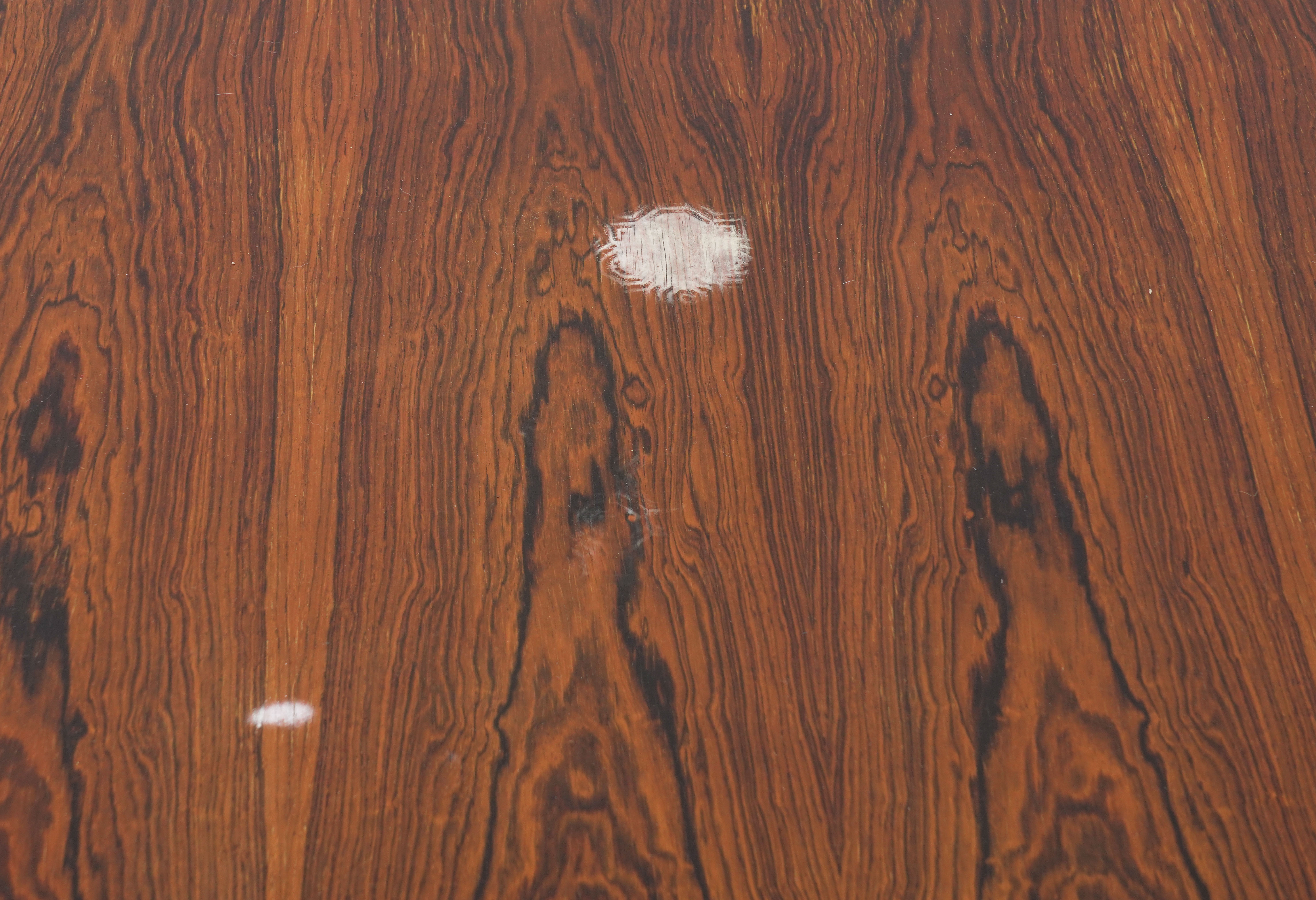 PROBABLY ARCHIE SHINE FOR HEALS FURNITURE; A MID-20TH CENTURY ROSEWOOD CIRCULAR DINING TABLE - Image 10 of 11