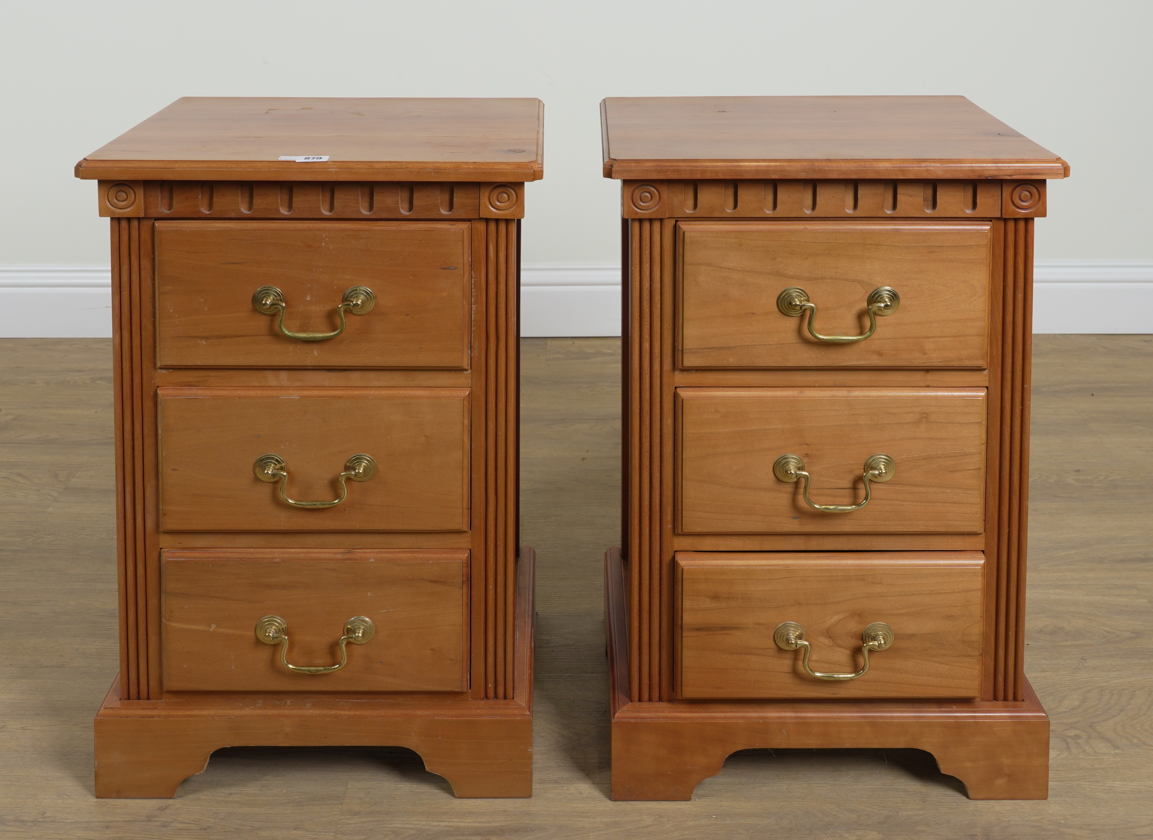 A PAIR OF 20TH CENTURY FRUITWOOD THREE DRAWER BEDSIDE CHESTS (2)