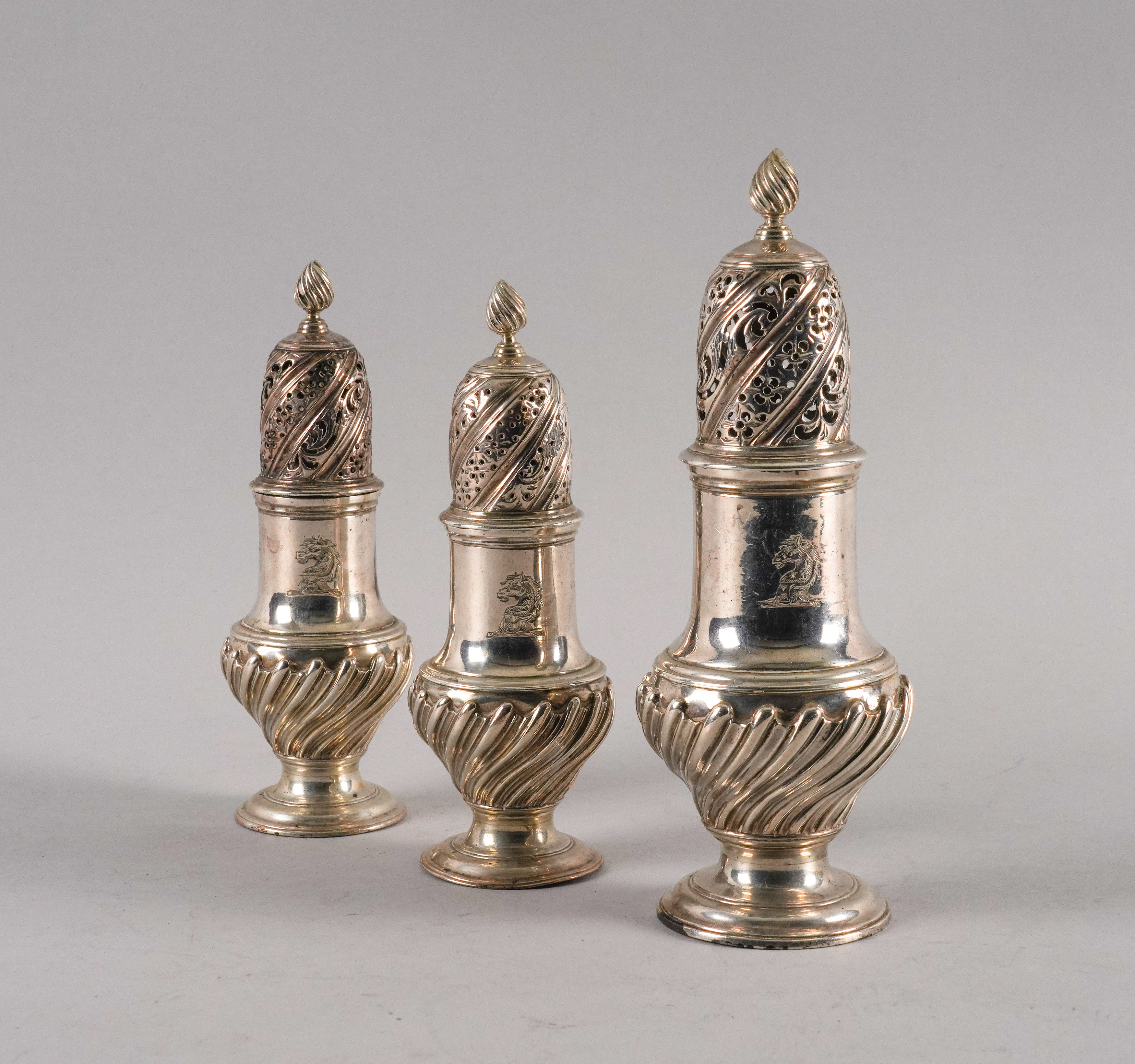A SET OF THREE LATE GEORGE II SILVER CASTERS (3)