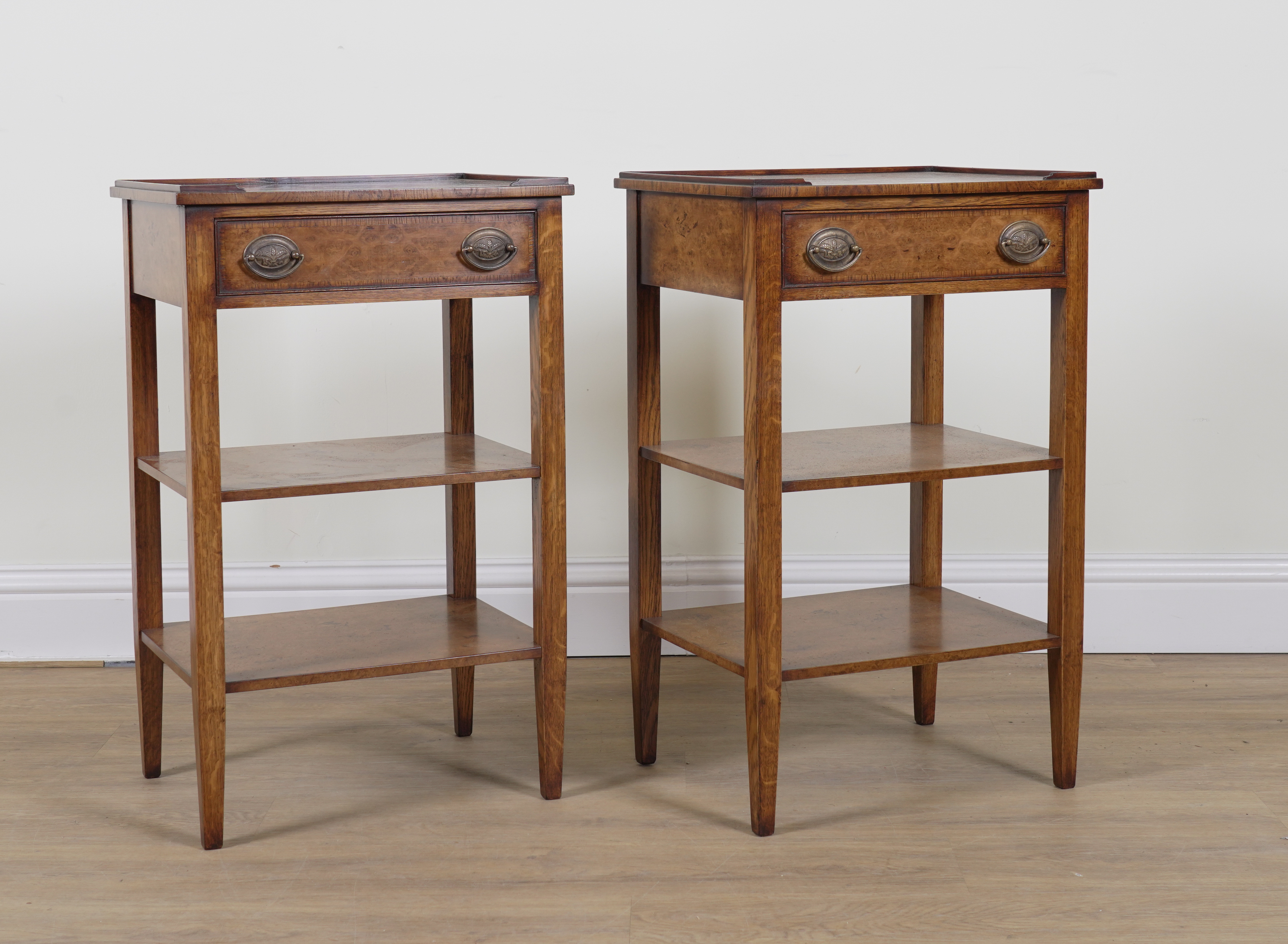 A PAIR OF FIGURED WALNUT SINGLE DRAWER THREE TIER RECTANGULAR SIDE TABLES (2)