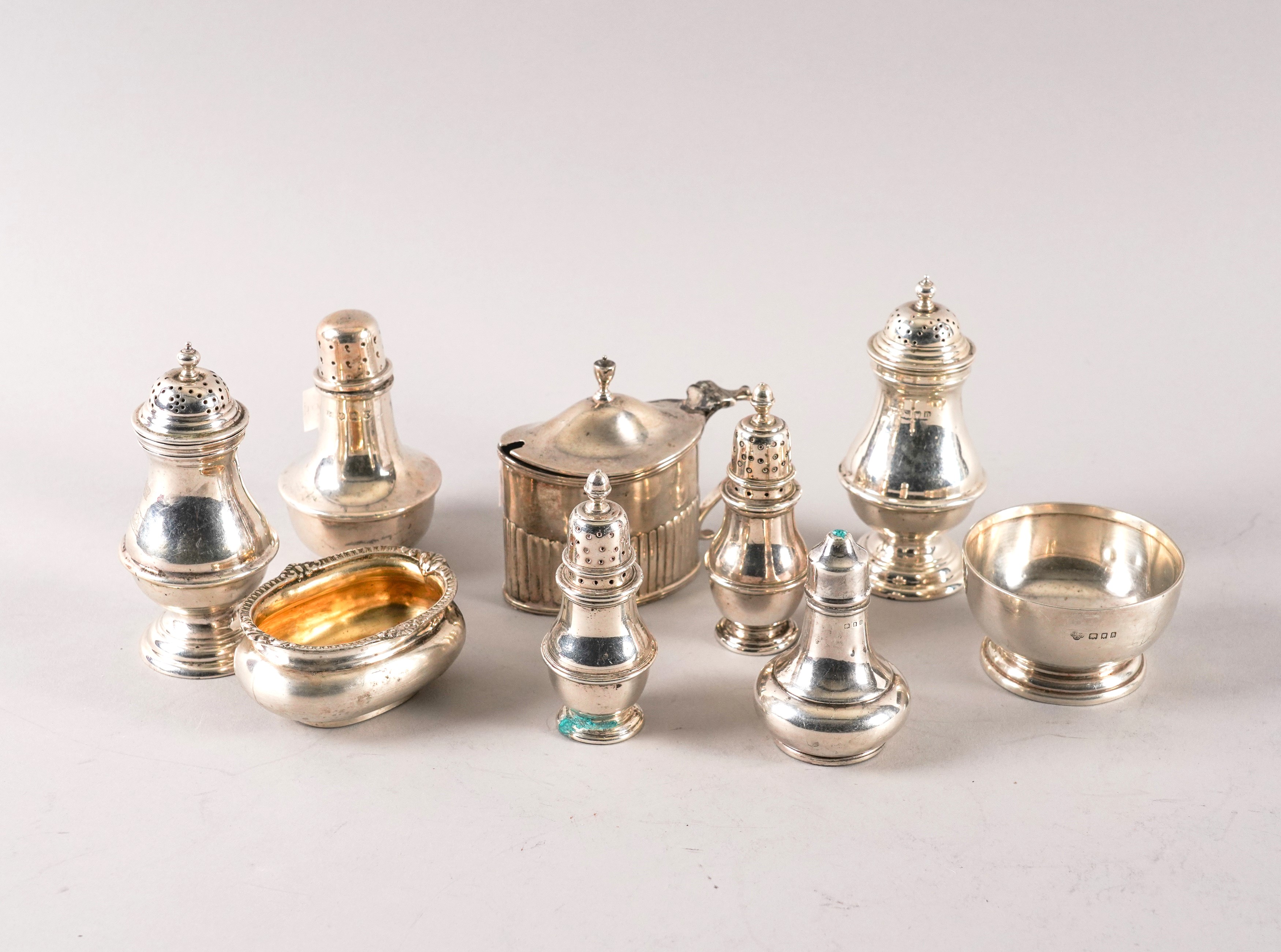 A GROUP OF EIGHT SILVER CONDIMENTS (9)