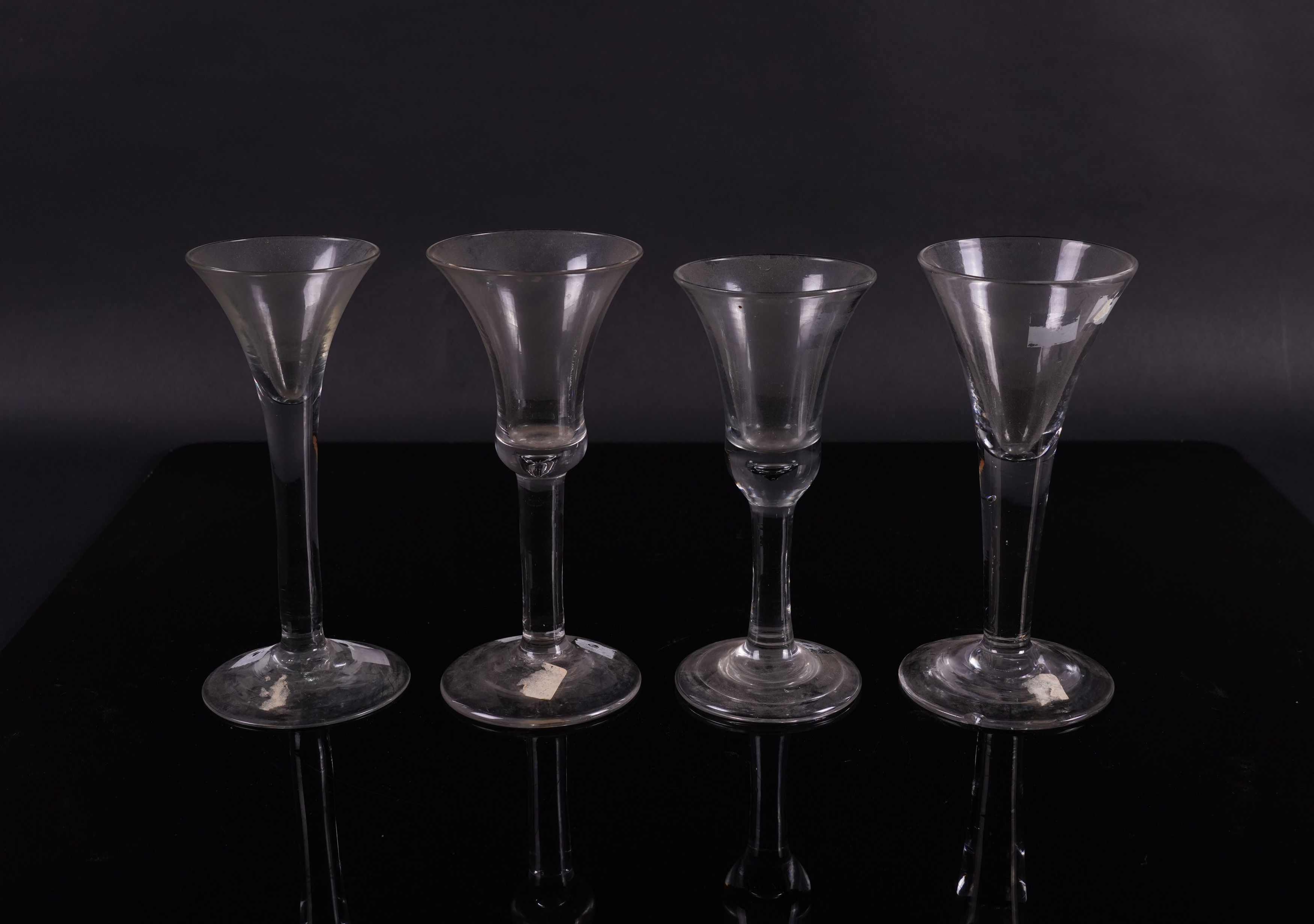 FOUR PLAIN STEMMED WINE GLASSES (4)