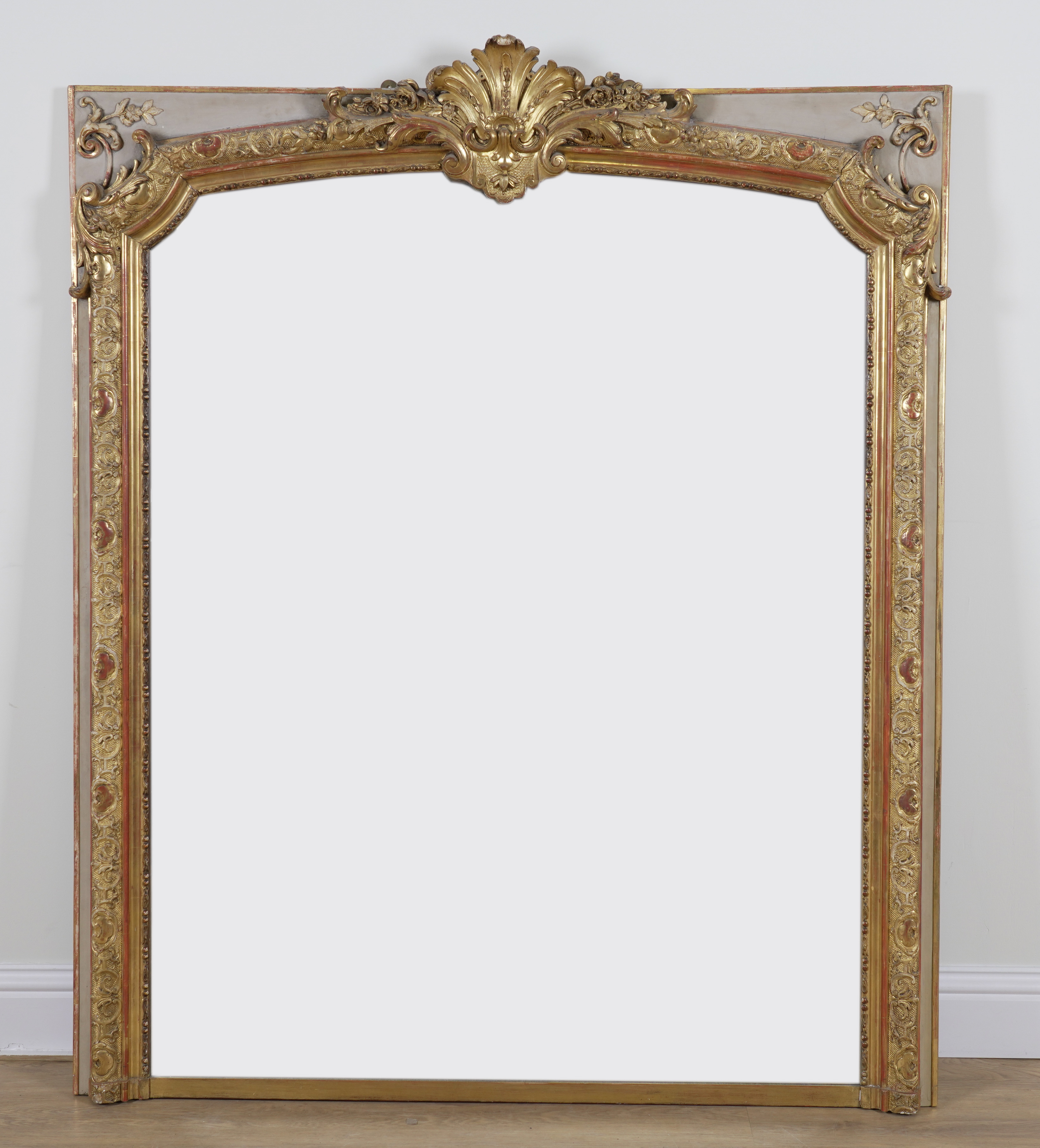 A 19TH CENTURY FRENCH CREAM PAINTED PARCEL GILT FRAMED OVERMANTEL MIRROR