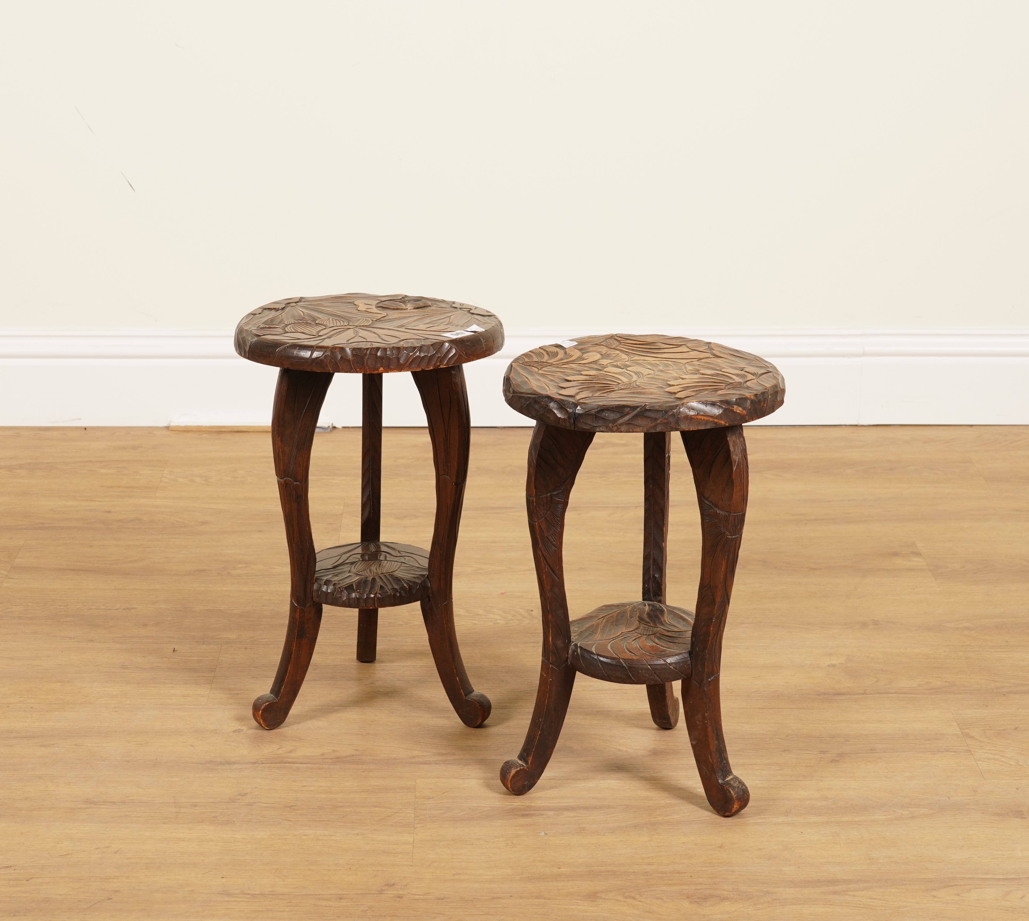LIBERTY & CO; A PAIR OF FLORAL CARVED CIRCULAR SIDE TABLES (2)