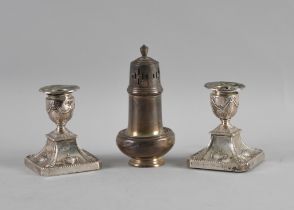 A PAIR OF SILVER CANDLESTICKS AND A SILVER SUGAR CASTER (3)