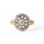 A GOLD AND SILVER SET DIAMOND CLUSTER RING