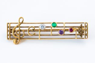 A GOLD AND GEMSTONE SET BROOCH