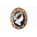 A BANDED AGATE OPAL AND ENAMELLED CAMEO BROOCH