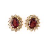 A PAIR OF GARNET AND DIAMOND CLUSTER EARRINGS, BOXED