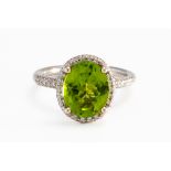 A PERIDOT AND DIAMOND RING