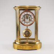 A FRENCH BRASS OVAL FOUR-GLASS MANTEL CLOCK