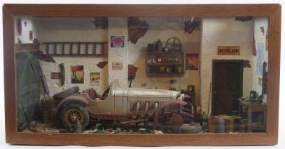 Automobilia: A vintage cased detailed diorama depicting a 1920’s Mercedes in a garage setting,