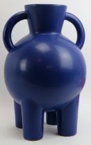 A large Habitat twin handled blue monochrome glazed ceramic vase. Supported on four cylindrical