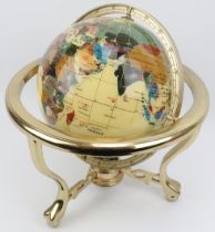 A terrestrial globe inlaid with a variety of stones and abalone shell, late 20th century. The