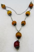 A vintage white metal & amber necklace, consisting of eight amber beads, each amber approx 28mm x