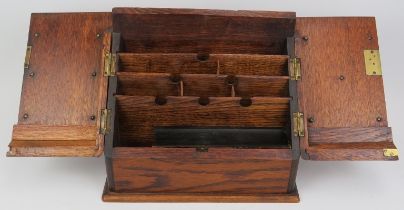 A late Victorian oak stationery letter box. The hinged double doors opening to a reveal tiered