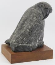 A carved granite stone sculpture of a bird, mid/late 20th century. Supported on a wooden plinth.