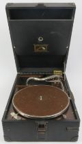 A vintage His Masters Voice (HMV) portable picnic gramophone, circa 1930’s. With a disc holder to