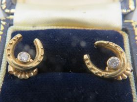 A pair of 9ct yellow gold horseshoe shaped earrings set with small centre diamond, boxed. Approx