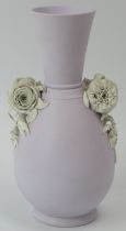 A lilac ground jasperware vase with applied floral decoration in relief. Probably by Wedgwood and