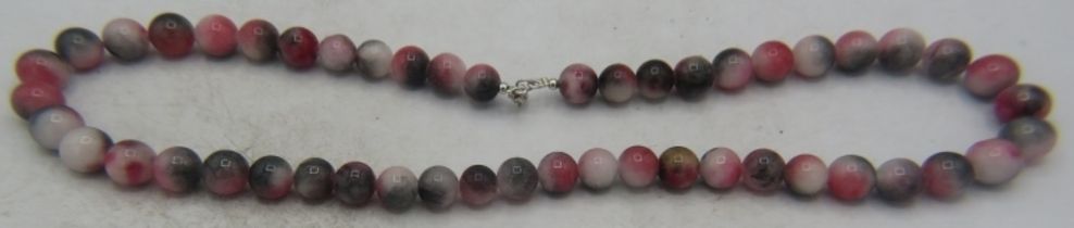 Watermelon jade necklace, 20" length, approx weight 68 grams. 8mm even size beads. Clasp stamped