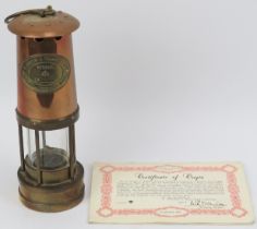 A Thomas & Williams Ltd brass and copper Cambrian miners flame safety lamp, 20th century. With a