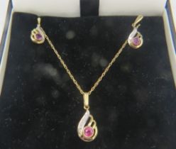 A 9ct yellow gold & diamond pendant on a fine metal chain, clasp marked 9ct and a pair of matching