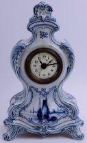 A German Delft ceramic mantle clock. French brass movement. Identical in style to German clocks