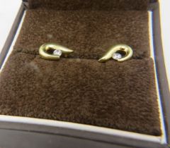 A pair of 9ct yellow gold earrings each set with a white stone, boxed. Approx weight 1.9 grams.