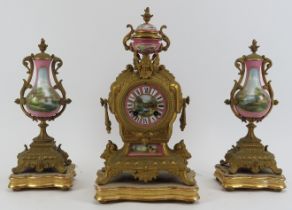 A French gilt brass and painted porcelain mantel clock with matching painted of garnitures, 19th