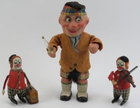 Three vintage clockwork tinplate toy model figures. Comprising a Schuco violin playing clown, a