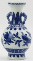 A Chinese blue and white porcelain twin handled vase, 19th century. Decorated with zoomorphic twin