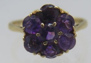 A 9ct yellow gold amethyst cluster ring, size N. Approx weight 2.4 grams.