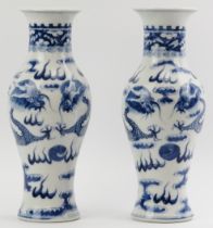 A pair of Chinese blue and white porcelain vases, 19th century. Decorated with confronting dragons