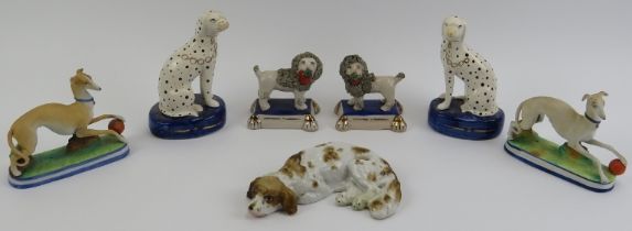A group of English and European ceramic dalmatian, poodle and spaniel dog figurines, 20th