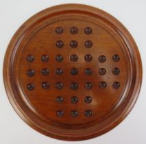 A Victorian turned mahogany solitaire board with marbles. Board: 29.8 cm diameter. Condition report: