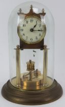 A gilt metal and brass 400 Day Anniversary torsion pendulum clock with glass dome, early 20th